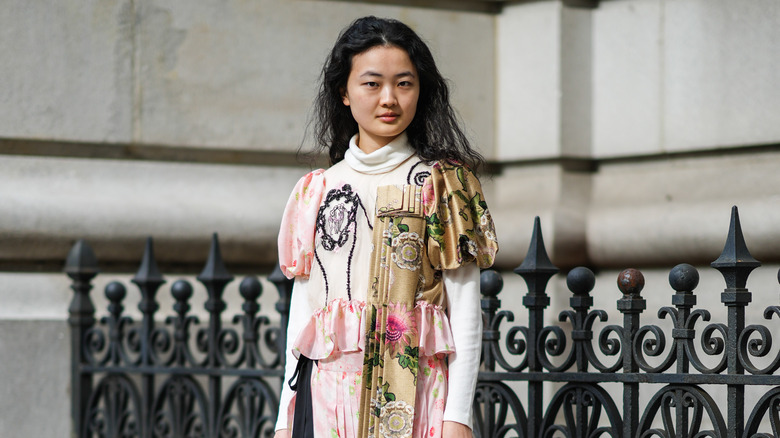 Individual in pink floral dress