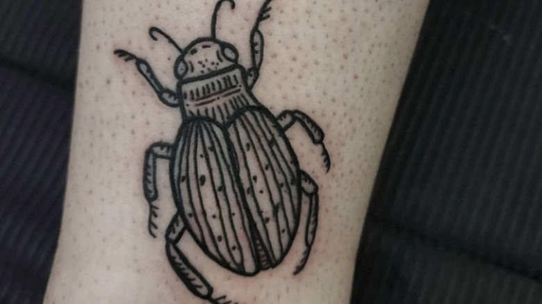 Beetle woodcut tattoo