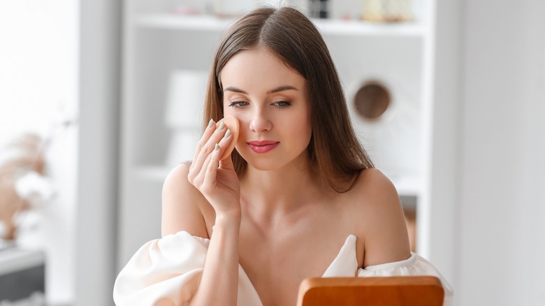 woman applying makeup