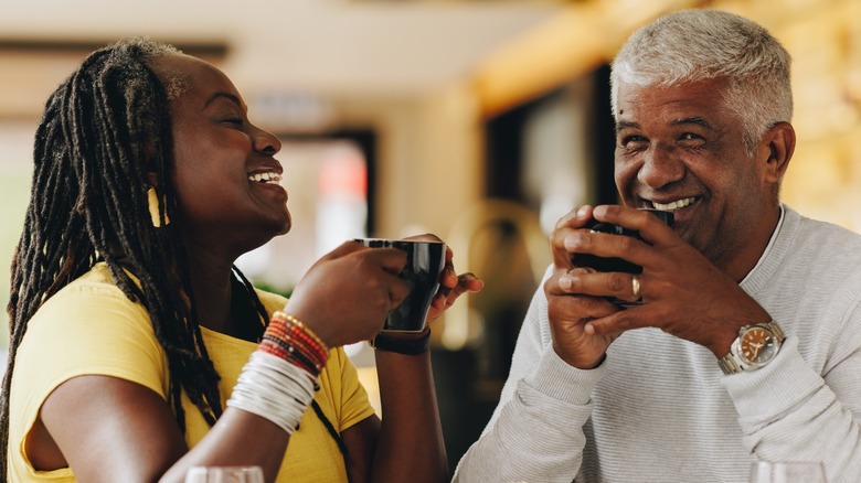 A couple laughing over coffee