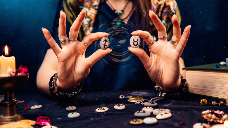 Woman holding zodiac stones