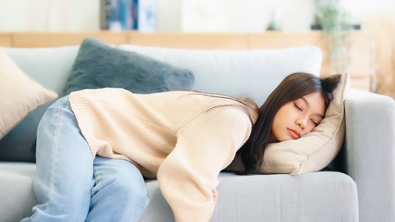 woman sleeping on sofa