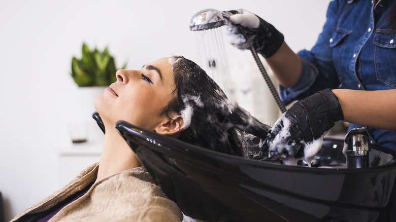 Indigenous woman getting hair treatment