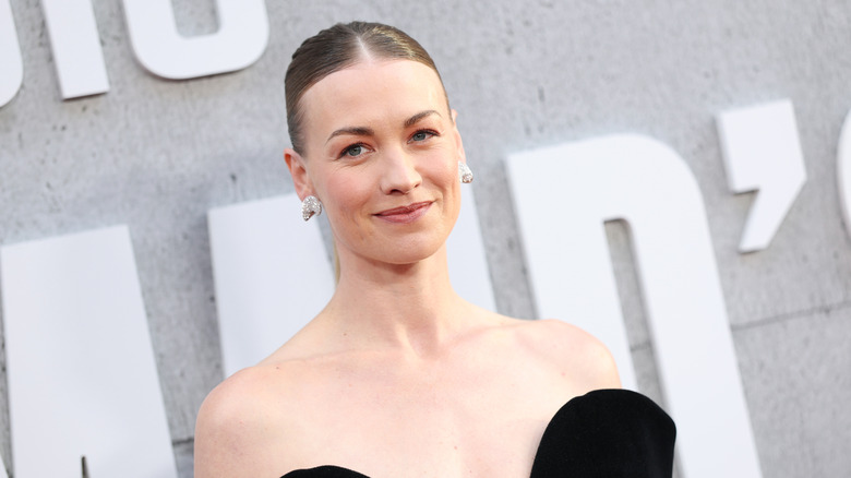 Yvonne Strahovski smiles wearing a strapless black dress