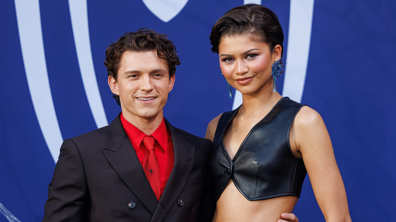 Tom Holland with his arm around Zendaya, who's rocking a short haircut