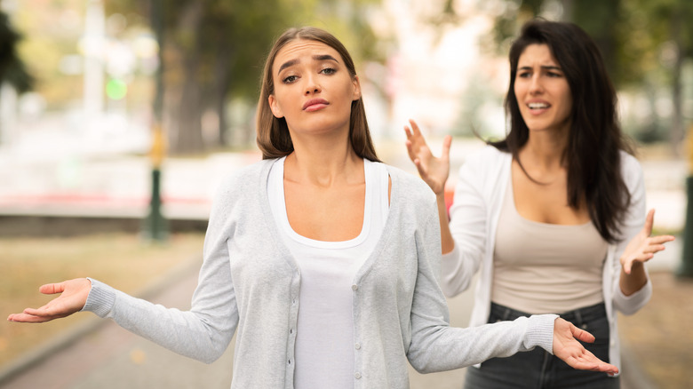 Friends walking outside arguing