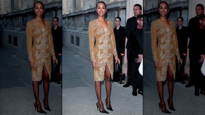 Zoe Saldaña wearing a beige midi dress with gold embellishments.