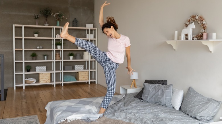 woman dancing on bed