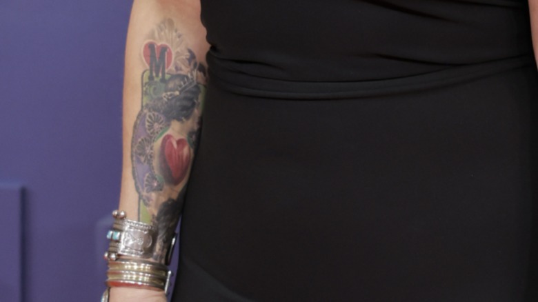 A close-up image of the wildcard tattoo on Miranda Lambert's forearm.