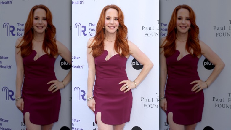 Amy Davidson in a short plum dress