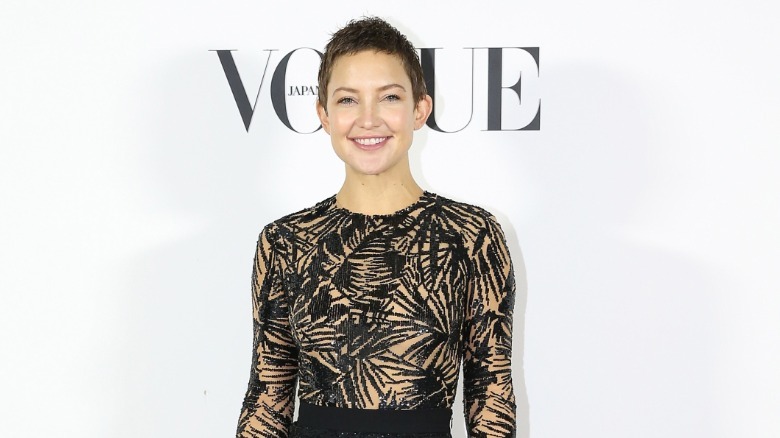 Kate Hudson smiles with a buzz cut