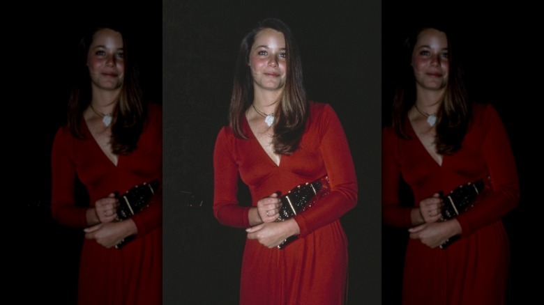 Susan Dey wearing a long-sleeved red dress.