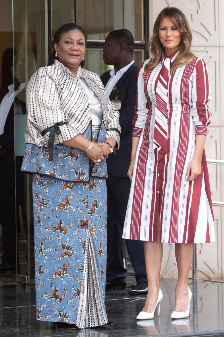 US First Lady Melania Trump in a $2000 designer dress and heels posing with Ghana's First Lady Rebecca Akufo-Addo as they visit an African Hospital