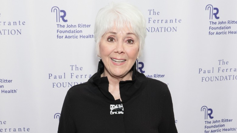 Joyce Dewitt wearing a black outfit with short white hair