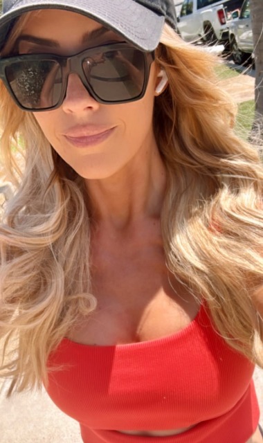 Christina Haack wearing long blond hair with a red top